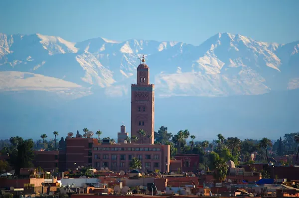 Minaret de la Koutoubia devant les sommets enneigés de l'Atlas